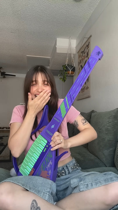 Woman holding a Cyber-G EVA guitar in a casual indoor setting