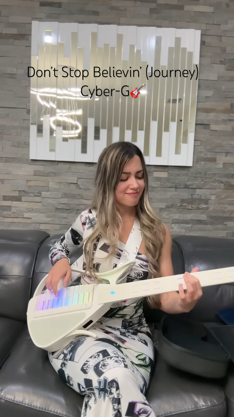 Woman playing a Cyber-G guitar in a room with a decorative wall art piece.