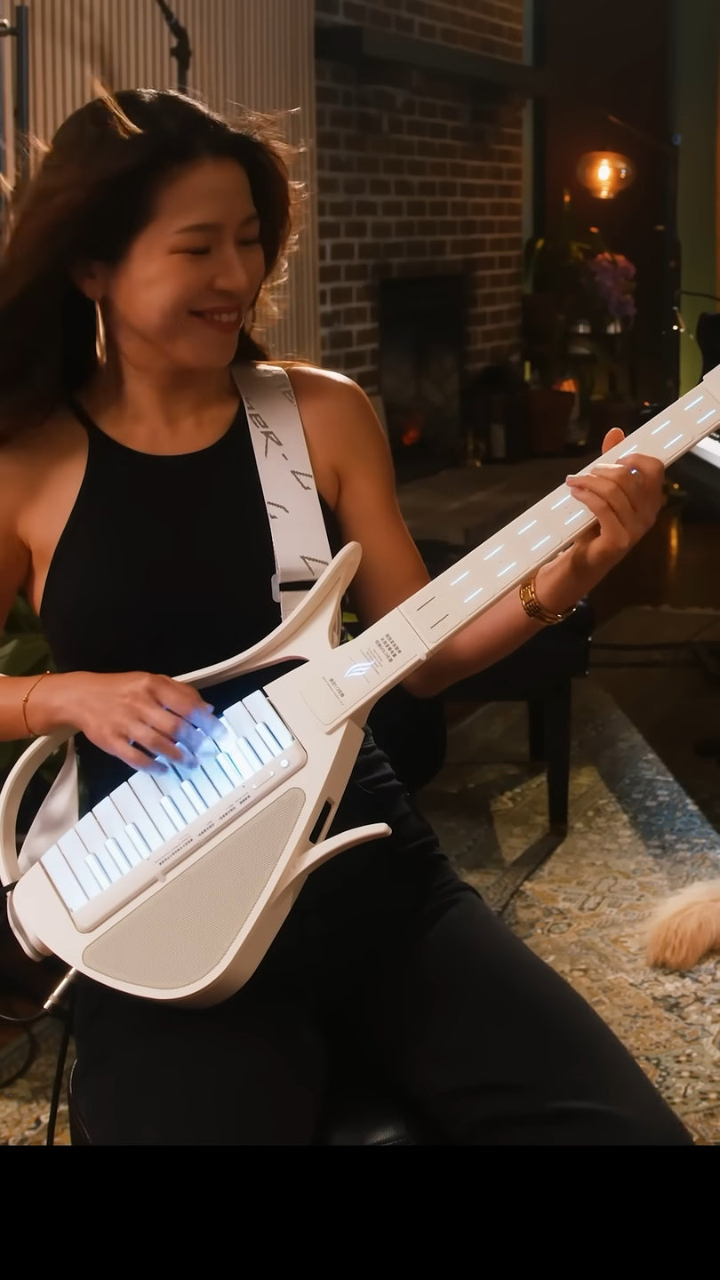 Woman playing a Cyber-G guitar in an indoor setting.
