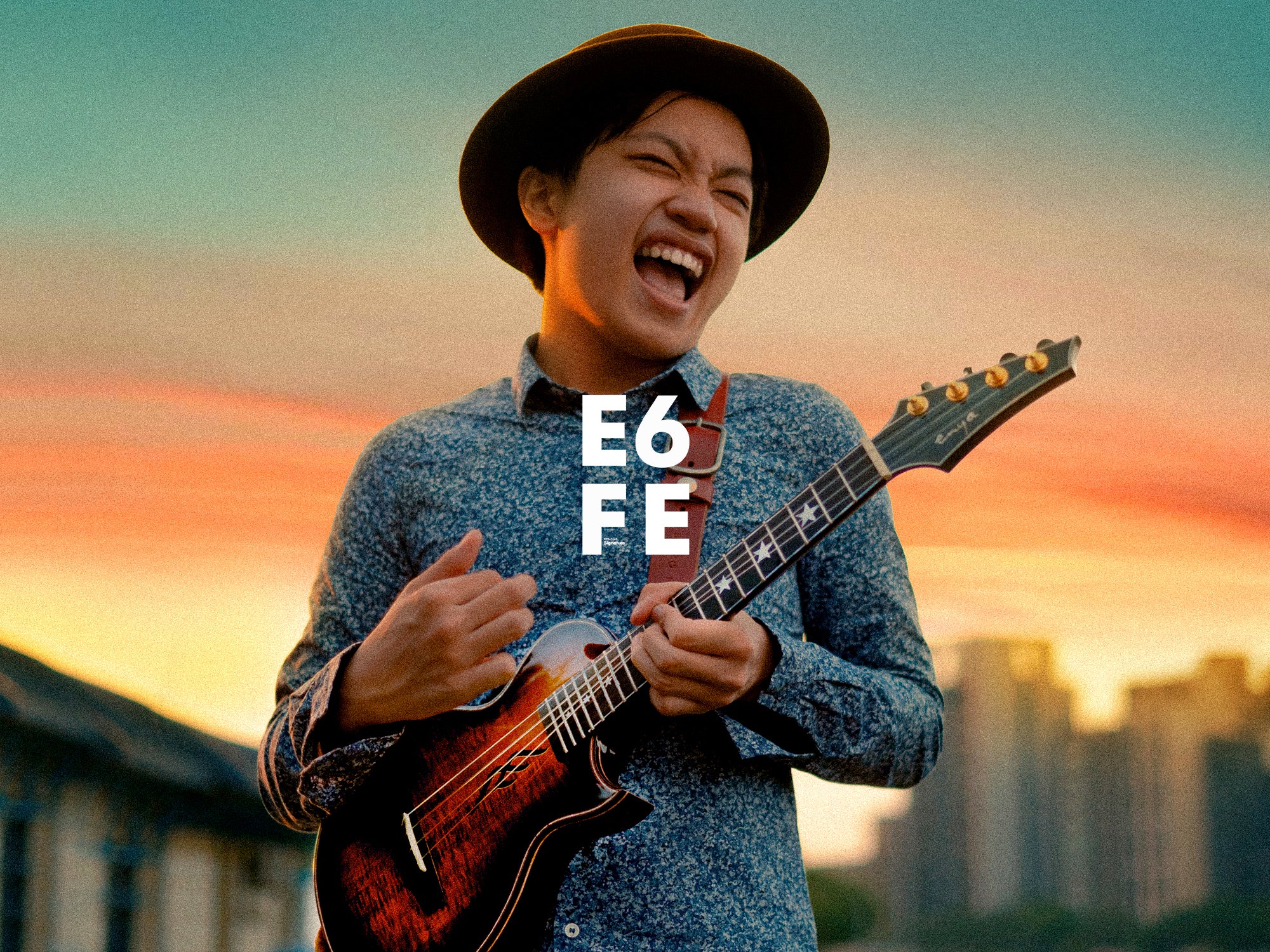 Feng E is playing his signature Ukulele E6, laughing and very enjoy.