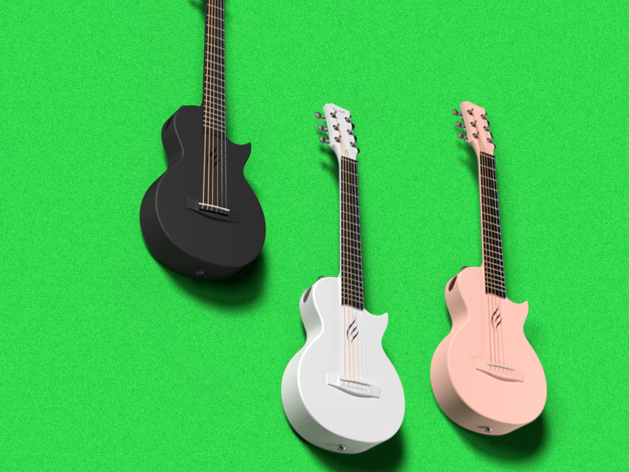 This picture shows 3 Nova Go Mini guitars in 3 different colors. From left to right, black, white, pink.