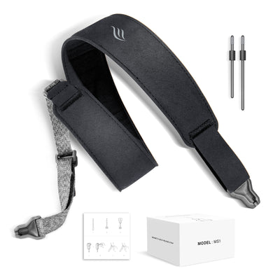 Black guitar strap with accessories on a white background