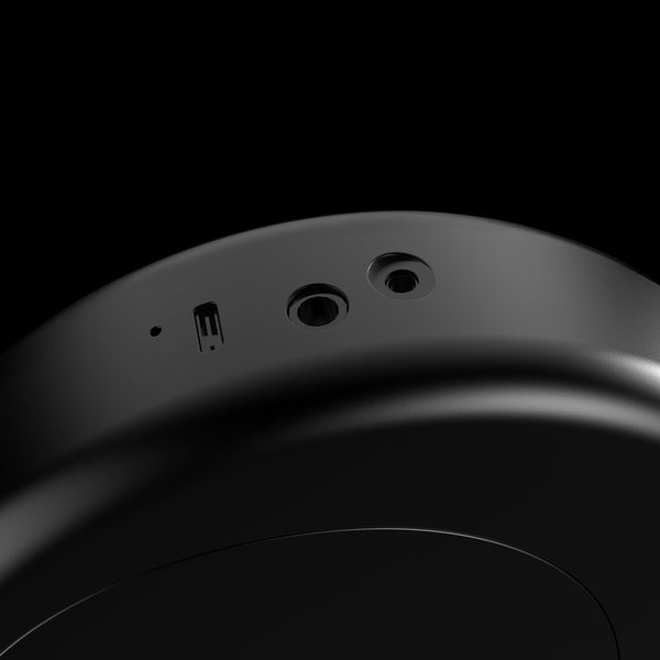 Close-up of a black electronic device with ports on a black background